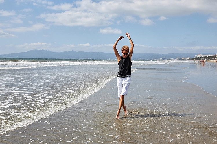 mature woman playing in the water at the beach