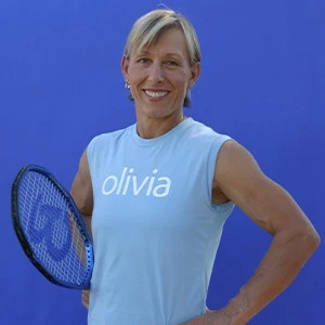 Martina Navratilova in an Olivai tshirt holding a tennis racket portrait